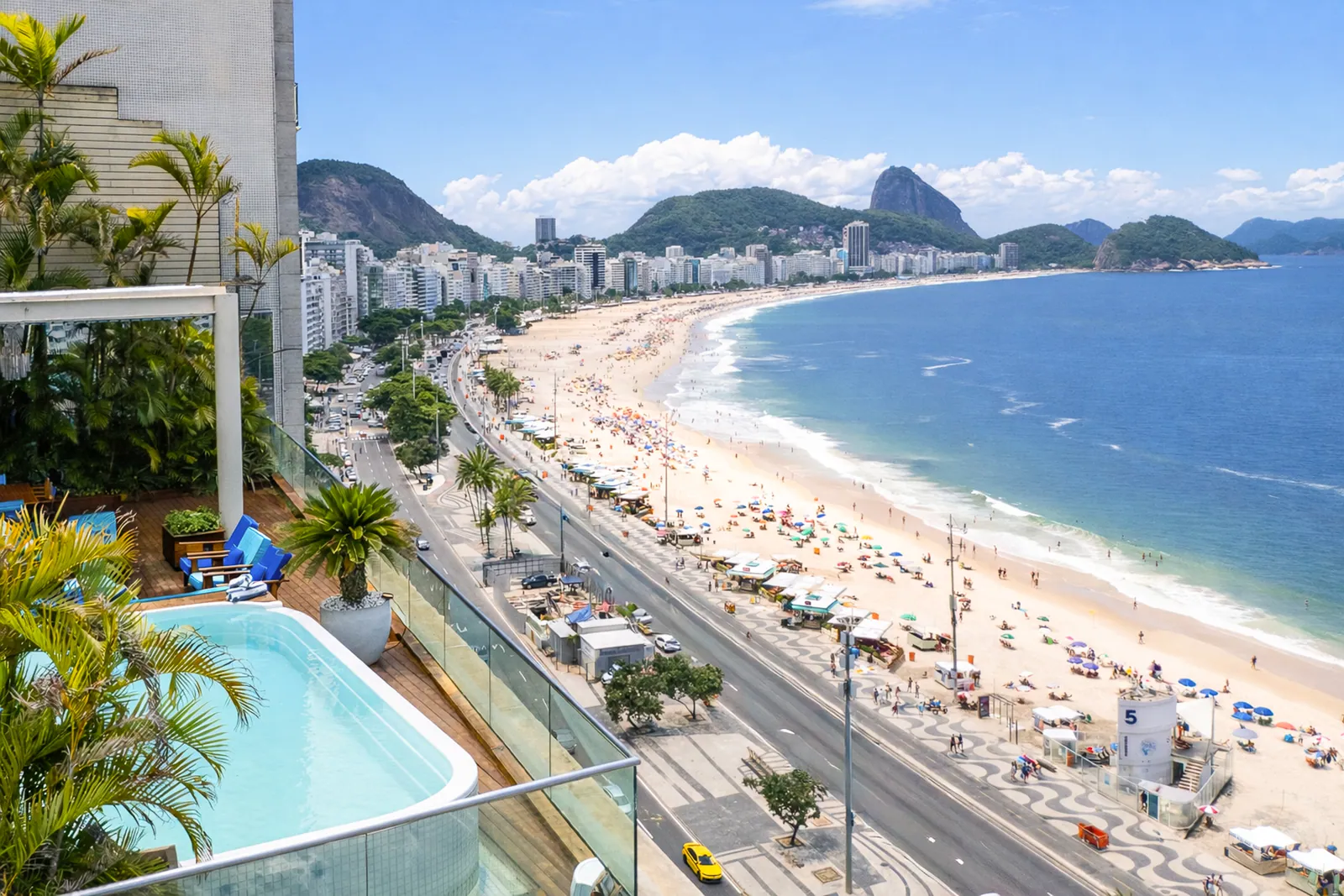 The full curve of Copacabana beach toward Sugarloaf, seen from the terrace