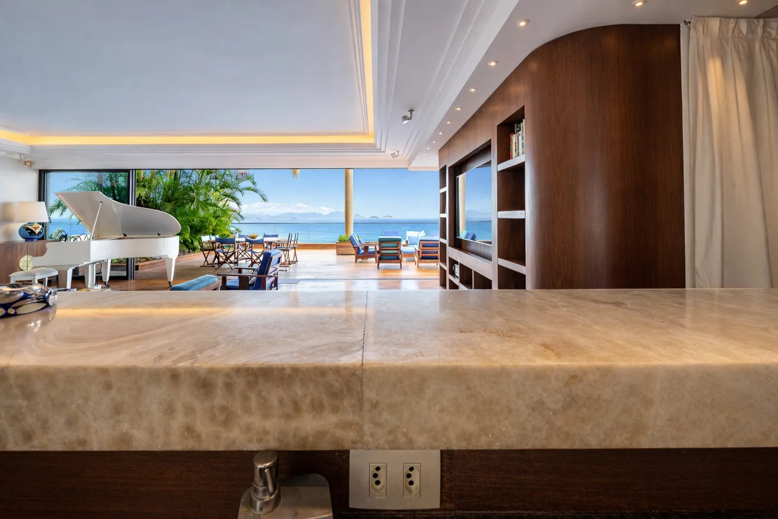 The bar in stone and wood, living room and piano beyond