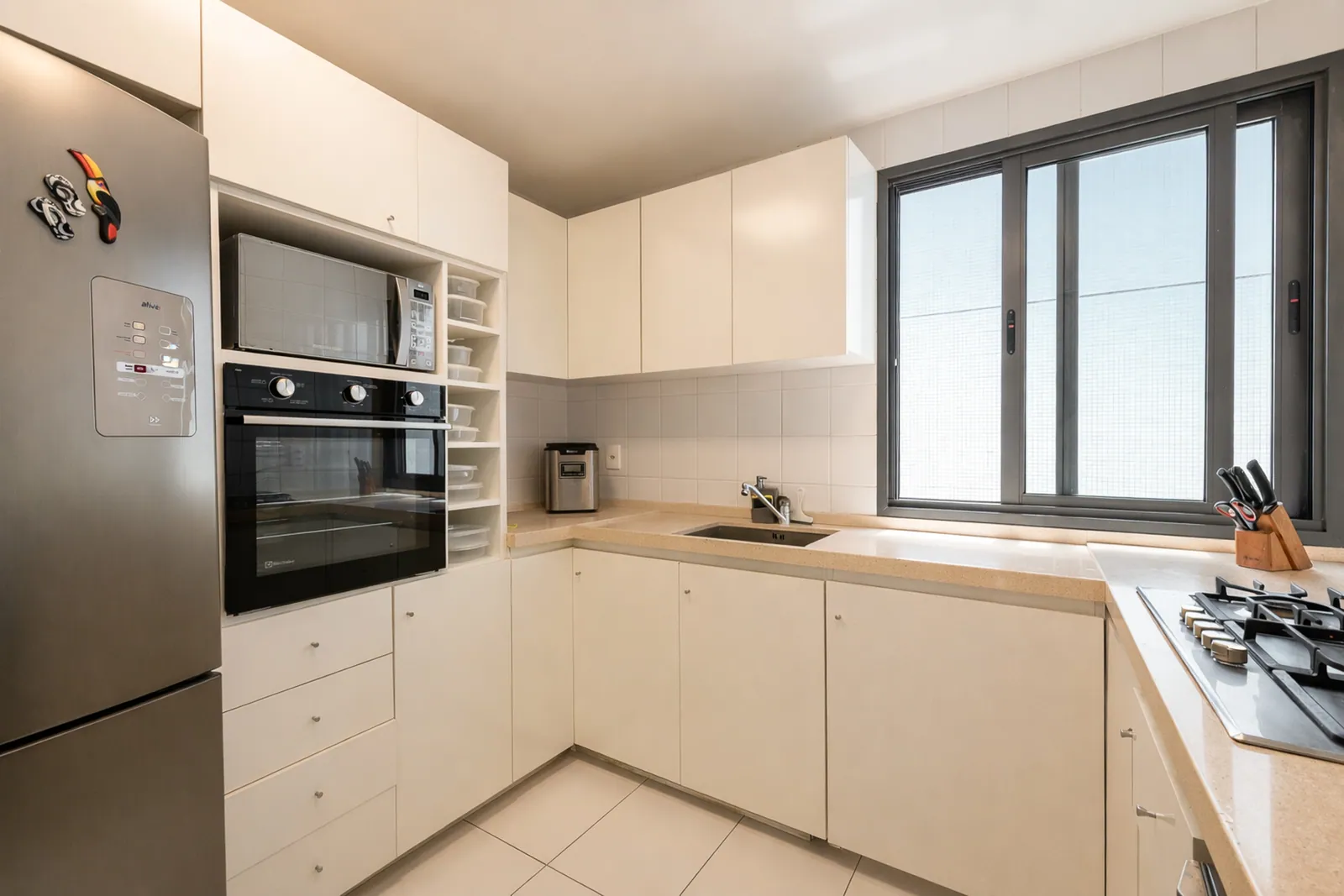 Second kitchen in white with full-height refrigerator