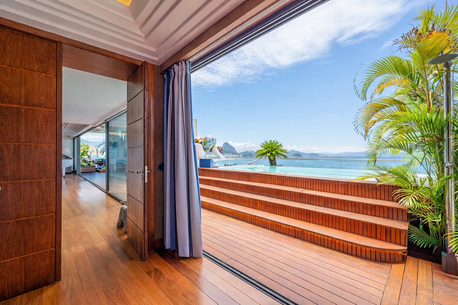Bedroom doors folding open onto the terrace and the sea