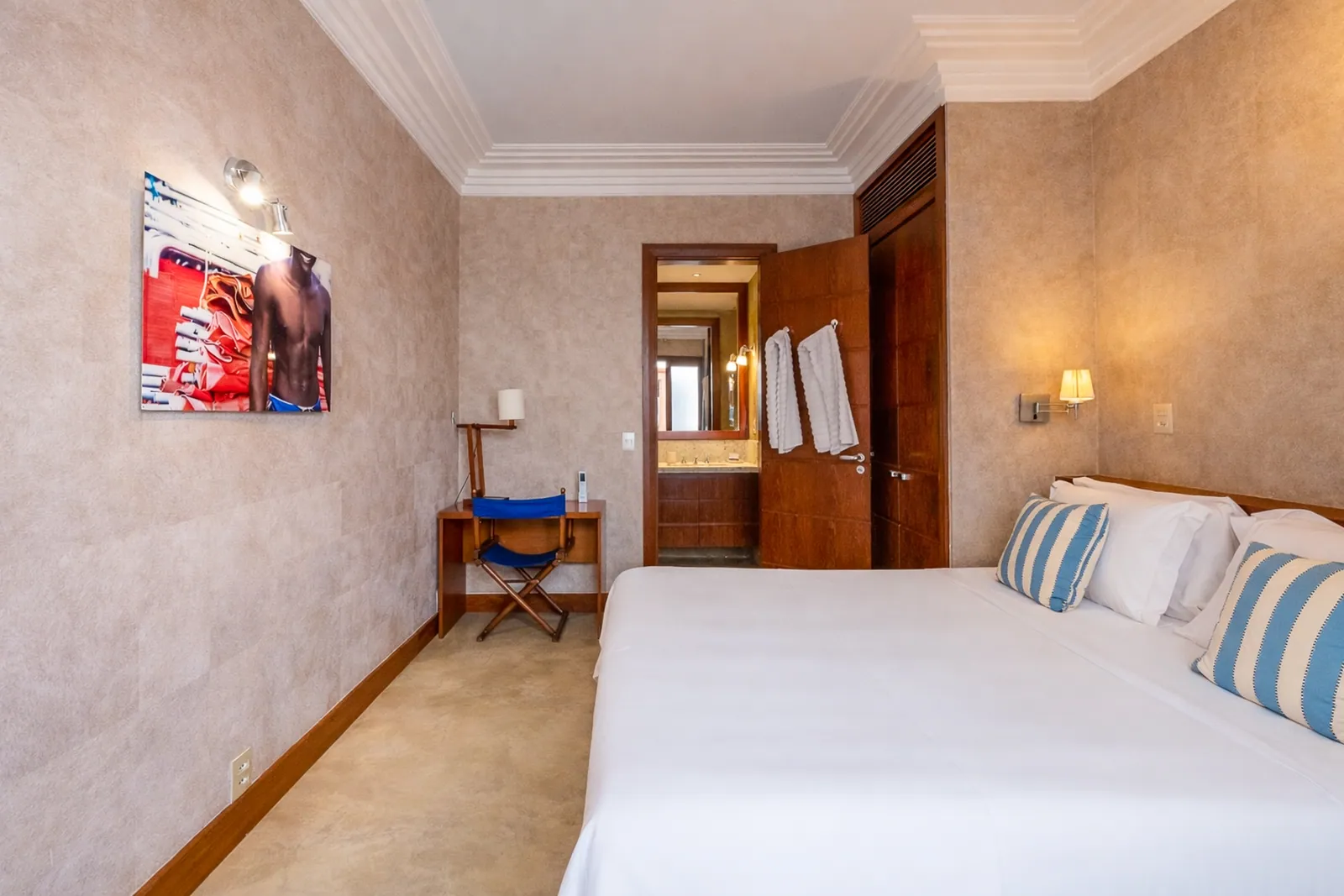 Bedroom with writing desk and framed artwork