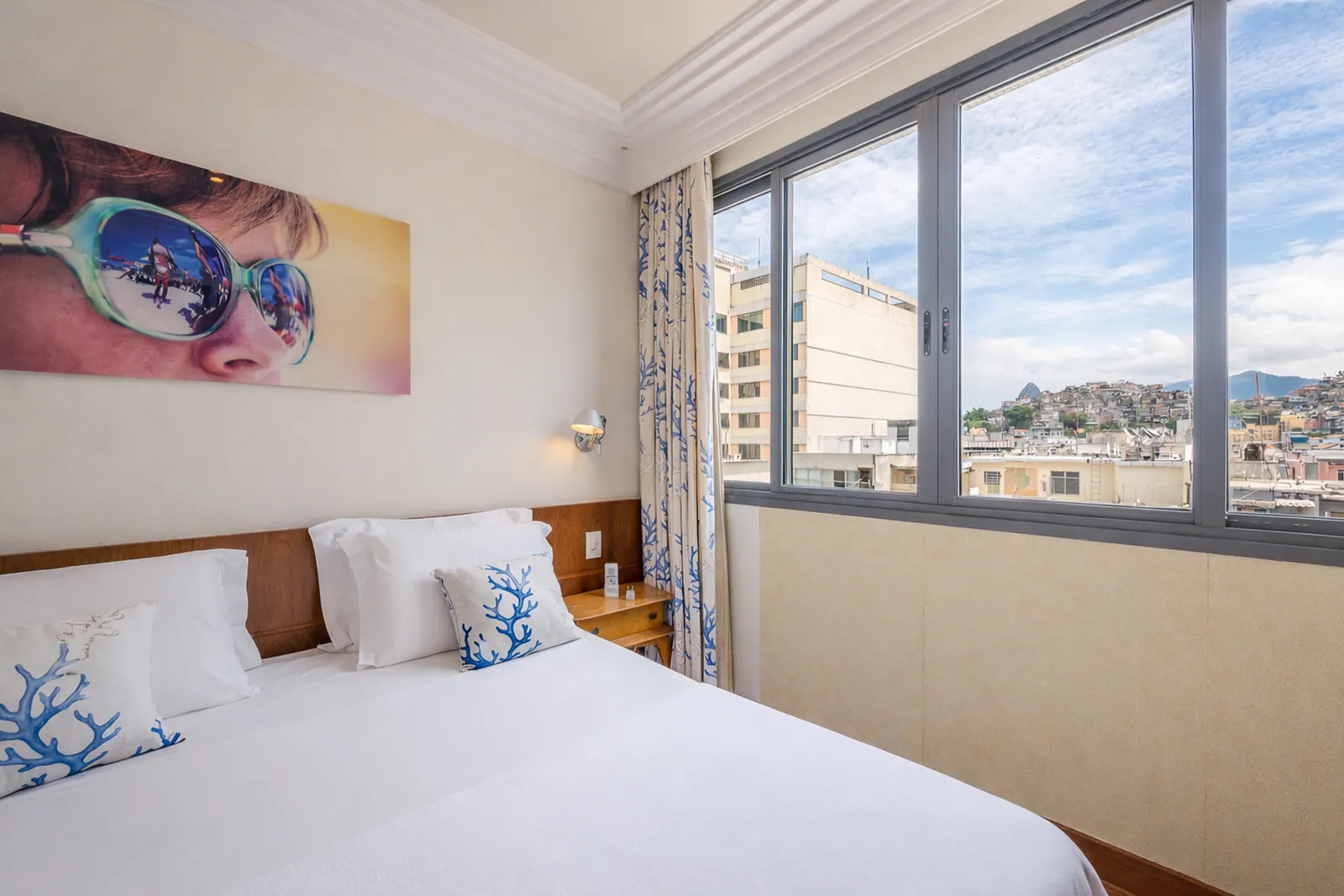 Twin bedroom with sliding windows onto the hills of Rio
