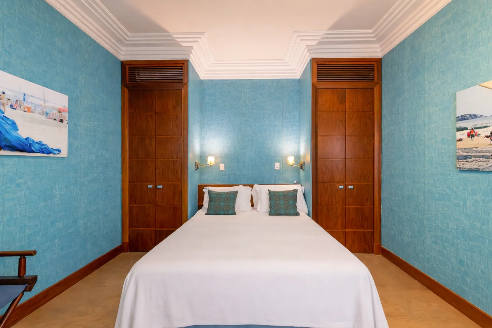 Bedroom with turquoise walls and fitted wood doors