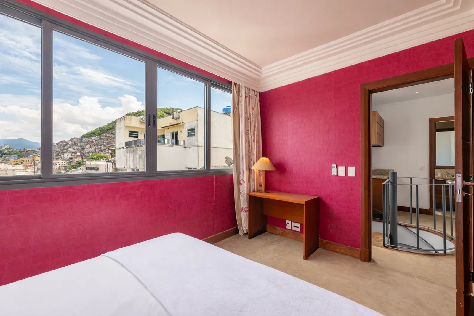 Pink bedroom on the upper floor, stairs through the doorway