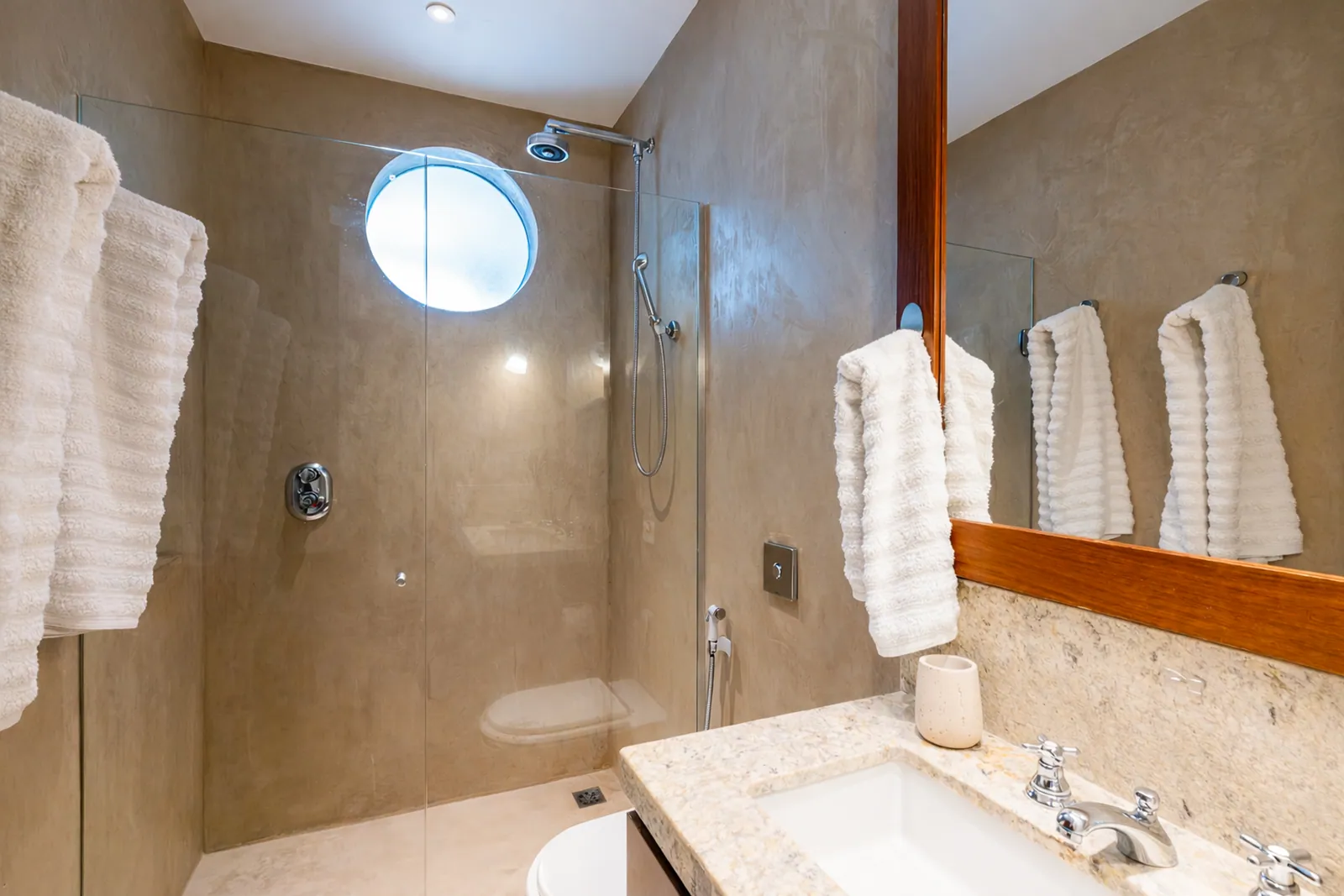 Shower and round porthole window in the bathroom