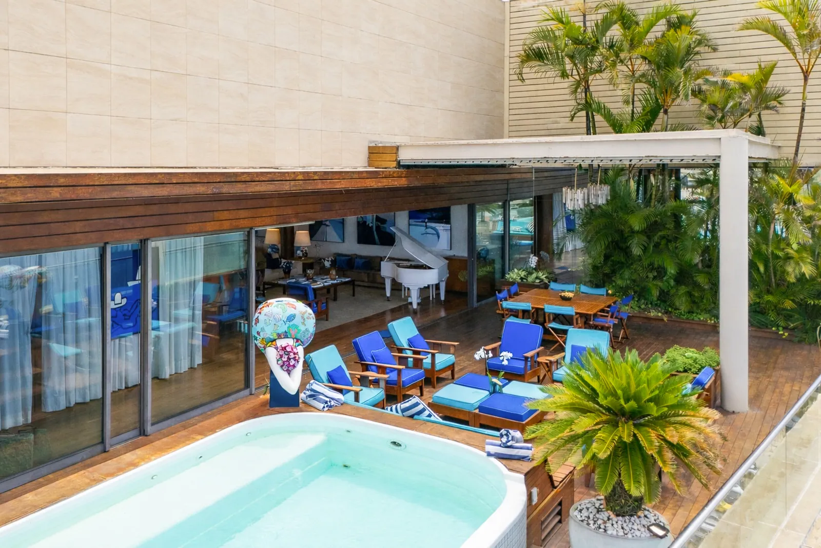 The pool set against the glass wall of the living room