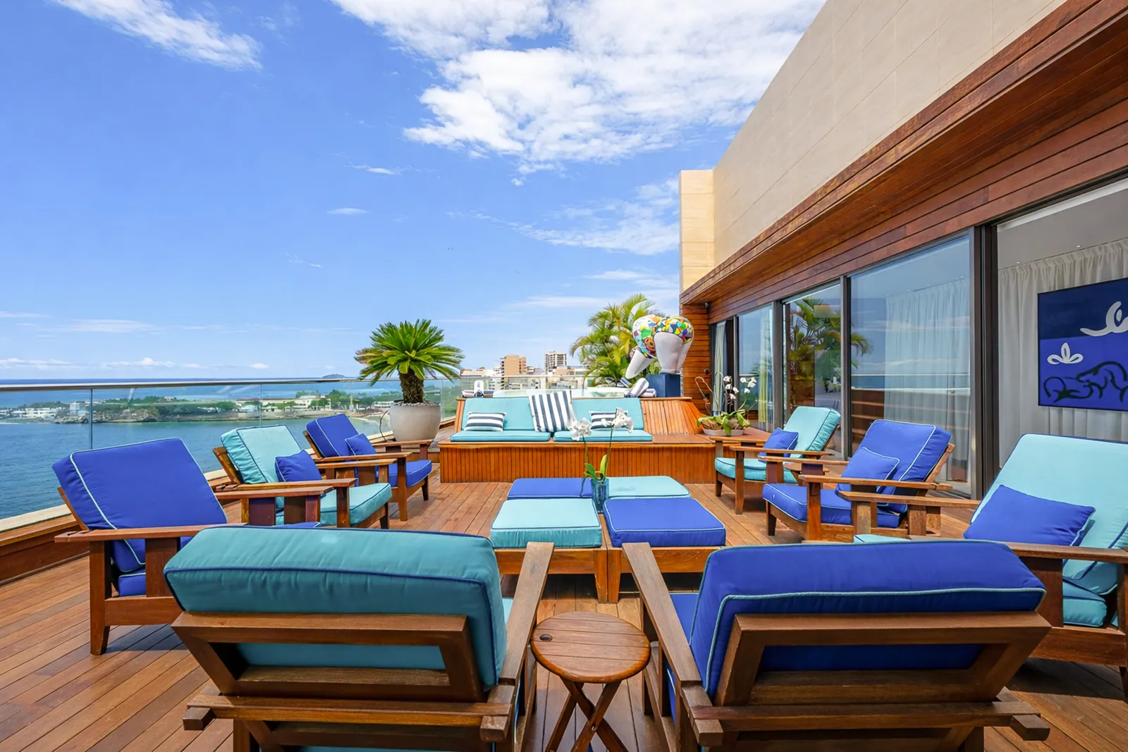 Loungers and dining table on the open terrace, sea ahead