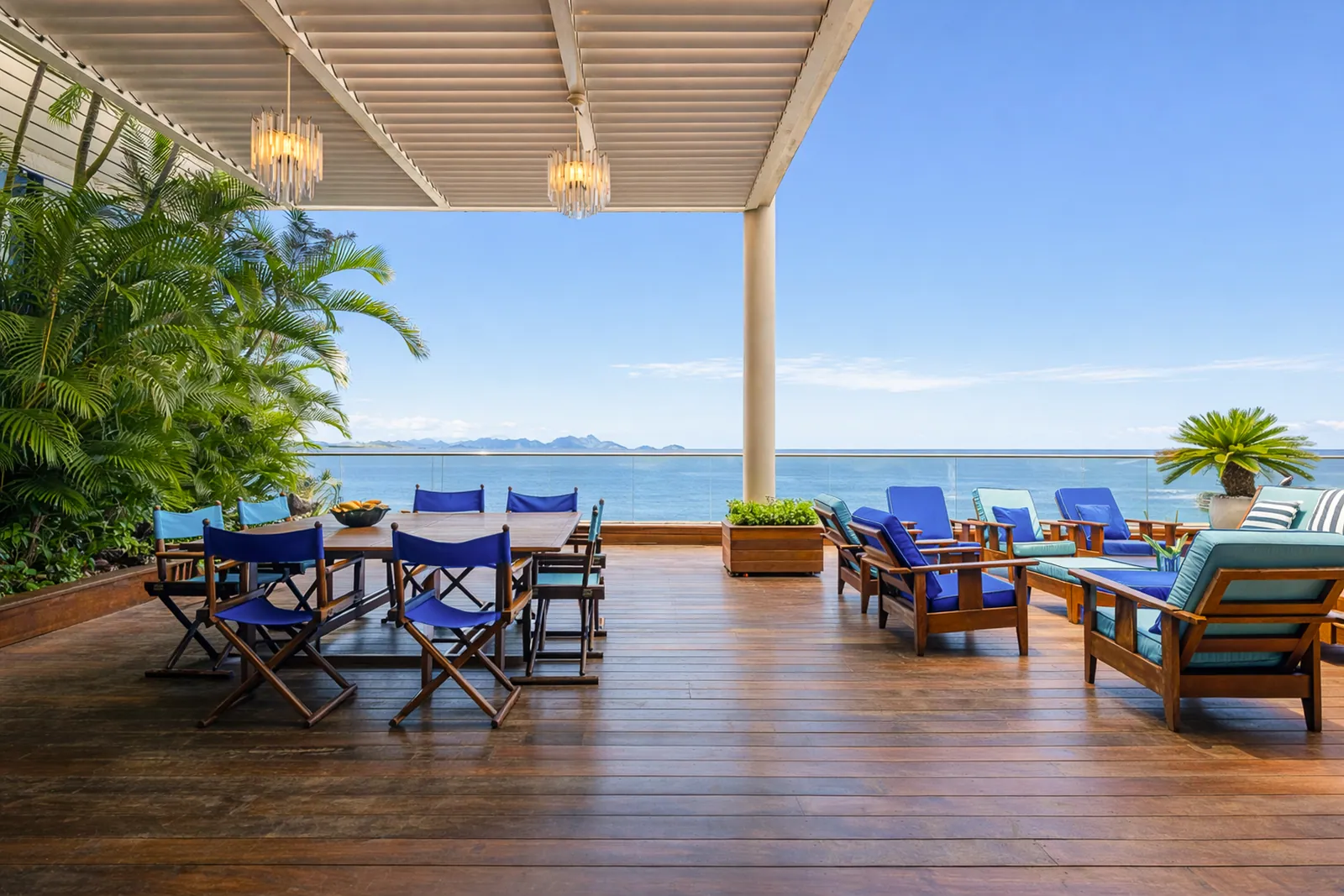 Directors' chairs on the covered terrace facing the water